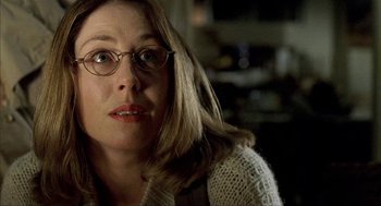 Movie still from “The One and Only” (1999), directed by Susanne Bier – A person wearing glasses and a sweater; Close Up shot, Low angle