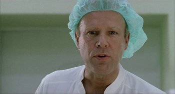Movie still from “The One and Only” (1999), directed by Susanne Bier – A person wearing a surgical cap; Close Up shot, Low angle