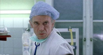 Movie still from “The One and Only” (1999), directed by Susanne Bier – A man wearing a surgical cap and a stethoscope; Close Up shot, Low angle