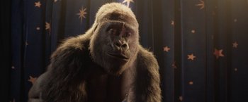 Movie still from “The One and Only Ivan” (2020), directed by Thea Sharrock – A gorilla in front of a blue curtain; Close Up shot, Low angle