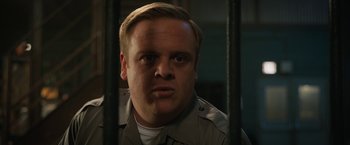 Movie still from “The One and Only Ivan” (2020), directed by Thea Sharrock – A person behind bars in a jail cell; Close Up shot, Low angle