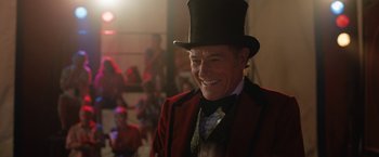 Movie still from “The One and Only Ivan” (2020), directed by Thea Sharrock – An older man wearing a red jacket and a black top hat; Close Up shot, Over the shoulder angle