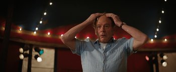 Movie still from “The One and Only Ivan” (2020), directed by Thea Sharrock – An older man holding his hands on top of his head; Close Up shot, Low angle