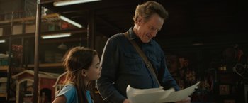 Movie still from “The One and Only Ivan” (2020), directed by Thea Sharrock – A man and a little girl looking at papers; Close Up shot, Over the shoulder angle
