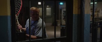 Movie still from “The One and Only Ivan” (2020), directed by Thea Sharrock – A man standing behind bars in a jail cell; Medium shot, Over the shoulder angle
