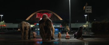 Movie still from “The One and Only Ivan” (2020), directed by Thea Sharrock – A group of people standing next to each other on the street; Extreme Wide shot, Low angle