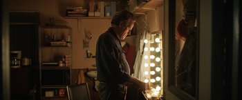 Movie still from “The One and Only Ivan” (2020), directed by Thea Sharrock – A man standing in front of a mirror in a room; Medium shot, Over the shoulder angle