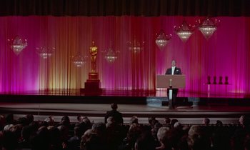 Movie still from “The Oscar” (1966), directed by Russell Rouse – A man standing at a podium in front of an audience; Extreme Wide shot, Low angle