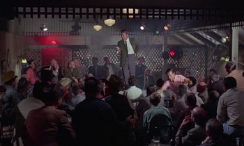 Movie still from “The Oscar” (1966), directed by Russell Rouse – A crowd of people sitting and standing in a room; Wide shot, High angle