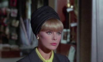 Movie still from “The Oscar” (1966), directed by Russell Rouse – A person wearing a hat and a suit; Close Up shot, Over the shoulder angle