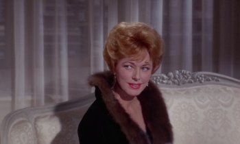 Movie still from “The Oscar” (1966), directed by Russell Rouse – An older woman wearing a black coat with a fur collar; Close Up shot, Low angle