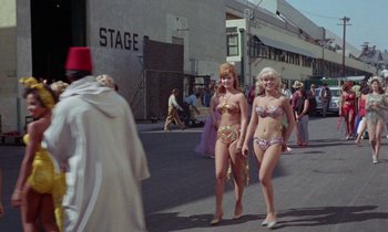 Movie still from “The Oscar” (1966), directed by Russell Rouse – Two women in bikinis walking down the street; Wide shot, High angle
