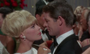Movie still from “The Oscar” (1966), directed by Russell Rouse – A man and a woman in formal wear at an event; Close Up shot, Low angle