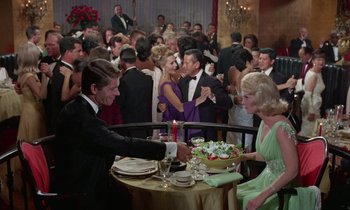 Movie still from “The Oscar” (1966), directed by Russell Rouse – A group of people in formal wear at a table; Wide shot, High angle