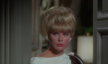 Movie still from “The Oscar” (1966), directed by Russell Rouse – A person wearing a white dress; Close Up shot, Over the shoulder angle