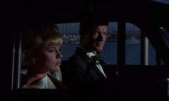 Movie still from “The Oscar” (1966), directed by Russell Rouse – A man and a woman sitting in the back of a car; Close Up shot, Over the shoulder angle