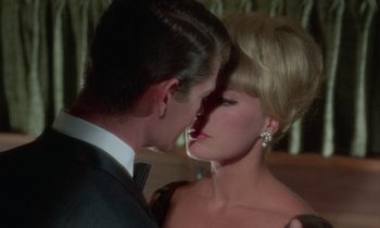 Movie still from “The Oscar” (1966), directed by Russell Rouse – A man and a woman kissing in front of a mirror; Close Up shot, Over the shoulder angle