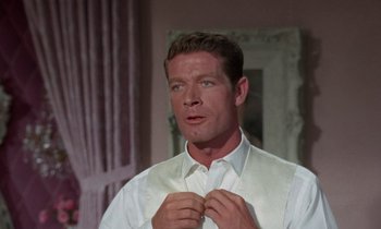 Movie still from “The Oscar” (1966), directed by Russell Rouse – A person wearing a shirt and tie; Close Up shot, Over the shoulder angle