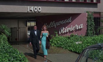Movie still from “The Oscar” (1966), directed by Russell Rouse – A man and a woman walking down the sidewalk; Wide shot, Low angle