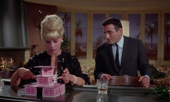 Movie still from “The Oscar” (1966), directed by Russell Rouse – A man and a woman sitting at a table; Medium shot, Low angle
