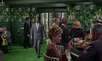 Movie still from “The Oscar” (1966), directed by Russell Rouse – A group of men and women in a room; Wide shot, High angle