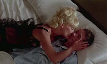 Movie still from “The Oscar” (1966), directed by Russell Rouse – A man and a woman laying in a bed kissing; Close Up shot, High angle