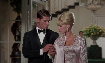 Movie still from “The Oscar” (1966), directed by Russell Rouse – A man and a woman standing next to each other in formal wear; Medium shot, Low angle