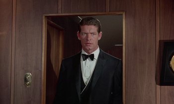Movie still from “The Oscar” (1966), directed by Russell Rouse – A man in a tuxedo standing in front of a mirror; Medium shot, Low angle