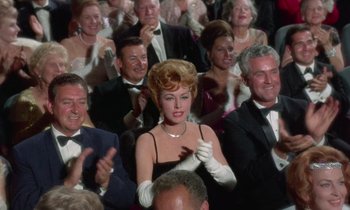 Movie still from “The Oscar” (1966), directed by Russell Rouse – A crowd of people in formal attire clapping; Medium shot, Low angle