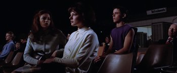 Movie still from “The Outsiders” (1983), directed by Francis Ford Coppola – A group of young people sitting in a room; Medium shot, Low angle