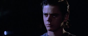 Movie still from “The Outsiders” (1983), directed by Francis Ford Coppola – A young man is looking into the distance; Close Up shot, Low angle