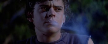 Movie still from “The Outsiders” (1983), directed by Francis Ford Coppola – A man's face in a dark room; Close Up shot, Low angle