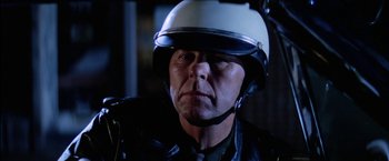 Movie still from “The Outsiders” (1983), directed by Francis Ford Coppola – A person wearing a motorcycle helmet; Close Up shot, Low angle
