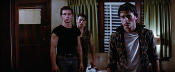 Movie still from “The Outsiders” (1983), directed by Francis Ford Coppola – A group of young men standing next to each other in a room; Medium shot, Low angle
