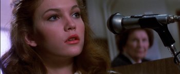 Movie still from “The Outsiders” (1983), directed by Francis Ford Coppola – A person using a hair dryer; Close Up shot, Low angle