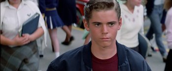 Movie still from “The Outsiders” (1983), directed by Francis Ford Coppola – A person wearing a red shirt; Close Up shot, Low angle