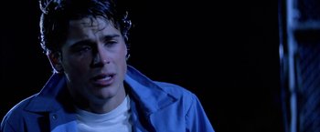 Movie still from “The Outsiders” (1983), directed by Francis Ford Coppola – A young man in a blue jacket is crying; Close Up shot, Over the shoulder angle