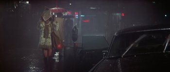 Movie still from “The Owl and the Pussycat” (1970), directed by Herbert Ross – A car parked on the side of the road in the rain; Wide shot, Over the shoulder angle