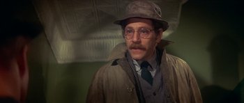 Movie still from “The Owl and the Pussycat” (1970), directed by Herbert Ross – A man wearing a hat and glasses and a jacket; Close Up shot, Low angle