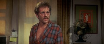 Movie still from “The Owl and the Pussycat” (1970), directed by Herbert Ross – A person wearing glasses and a plaid shirt; Close Up shot, Over the shoulder angle