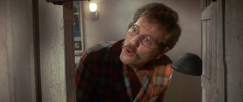 Movie still from “The Owl and the Pussycat” (1970), directed by Herbert Ross – A person wearing glasses and a plaid shirt; Close Up shot, Low angle