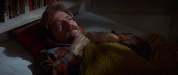 Movie still from “The Owl and the Pussycat” (1970), directed by Herbert Ross – A man laying on the ground with his hand under his chin; Close Up shot, Low angle