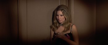 Movie still from “The Owl and the Pussycat” (1970), directed by Herbert Ross – A beautiful young lady holding a cell phone in front of her face; Close Up shot, High angle