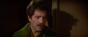 Movie still from “The Owl and the Pussycat” (1970), directed by Herbert Ross – A person with a beard and mustache; Close Up shot, High angle