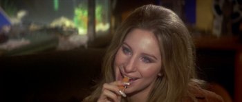 Movie still from “The Owl and the Pussycat” (1970), directed by Herbert Ross – A beautiful young lady holding a carrot in her mouth; Close Up shot, High angle