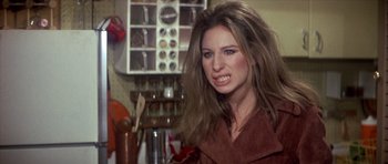 Movie still from “The Owl and the Pussycat” (1970), directed by Herbert Ross – A woman with long brown hair is posing for a picture; Close Up shot, Over the shoulder angle