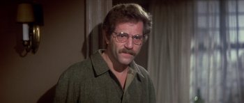 Movie still from “The Owl and the Pussycat” (1970), directed by Herbert Ross – A person wearing glasses and a jacket; Close Up shot, Over the shoulder angle