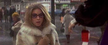 Movie still from “The Owl and the Pussycat” (1970), directed by Herbert Ross – A person walking on the street; Close Up shot, Over the shoulder angle