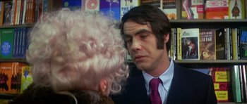 Movie still from “The Owl and the Pussycat” (1970), directed by Herbert Ross – A man in a suit and tie looking at a woman in a wig; Close Up shot, Over the shoulder angle