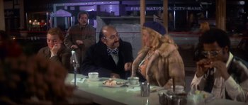 Movie still from “The Owl and the Pussycat” (1970), directed by Herbert Ross – A man and a woman sitting at a dinner table; Medium shot, Over the shoulder angle